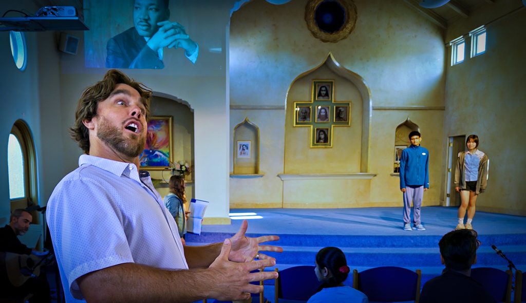 Teacher Craig Kellogg directs actors in a school play.