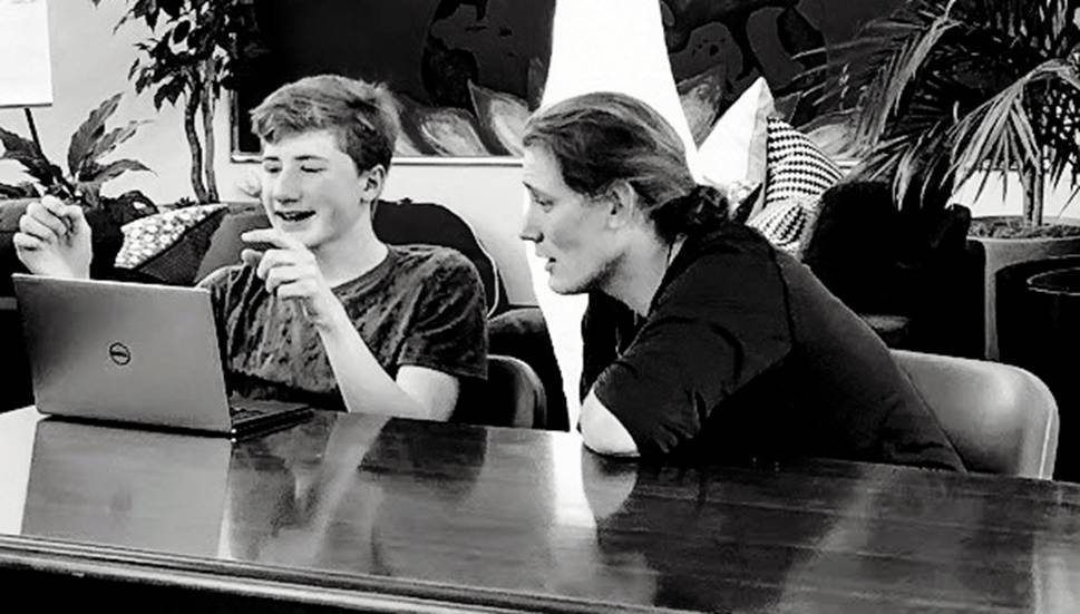 A working physicist from the Stanford Linear Accelerator Center tutors a student at Living Wisdom High School of Palo Alto, California.